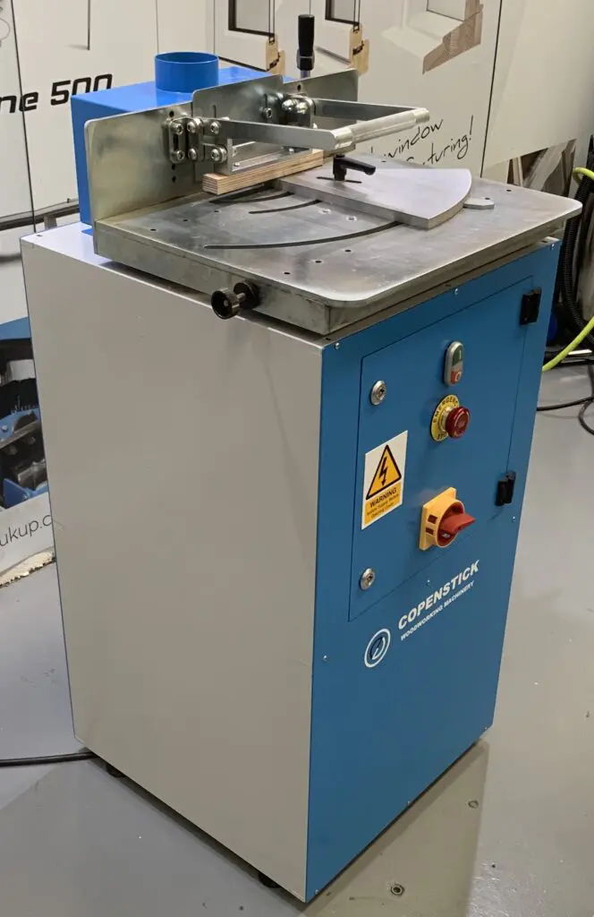 Copenstick woodworking machinery glazing beading machine with blue cabinet, red emergency stop button, and metal work table