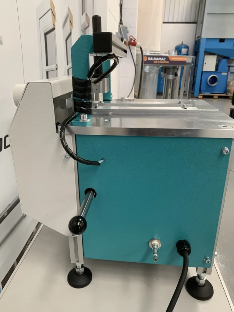 Teal and silver HEP glazing bead end profile scribing machine on a workbench in a workshop