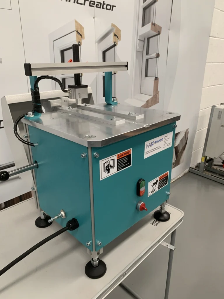 Teal HEP Glazing Bead End Profile Scribing Machine on a workbench, with warning labels and control buttons on the front panel.