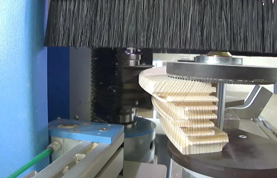 Soukup Arcus machining centre cutting curved wooden arch profiles, with rotating brush guard and milling spindle visible