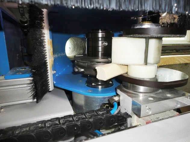 Close-up of internal mechanical components of a Soukup Arcus machining centre, including brushes, rollers, and routing heads.