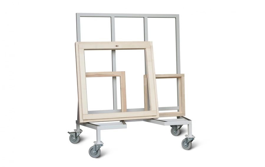 Metal trolley on castors holding multiple wooden and aluminium window frames of varying sizes upright