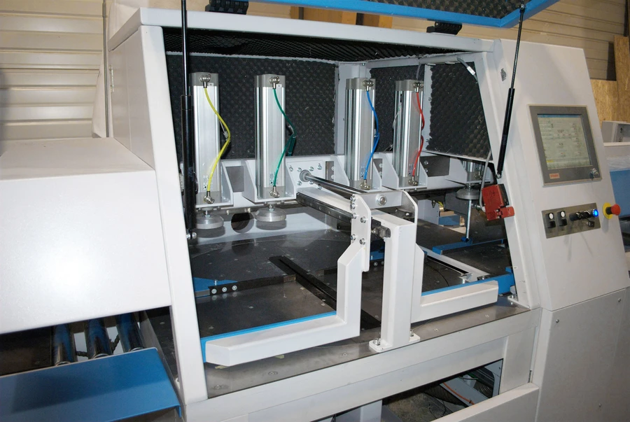 Soukup Crossline 650 automatic angle cross cut saw with open guard, pneumatic cylinders, and touchscreen control panel in a workshop