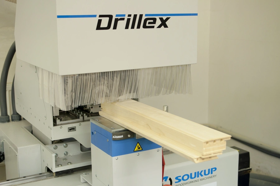 Soukup Drillex work centre drilling a timber wooden board with dust extraction bristles visible