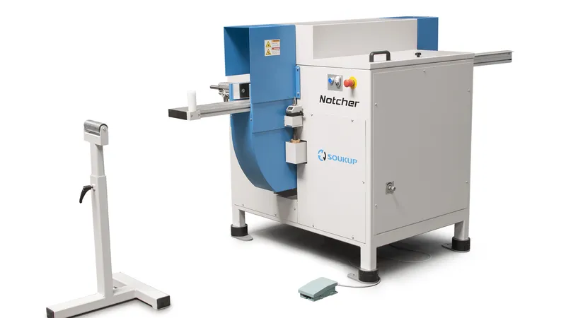 Soukup Notcher machine in white and blue with a roller support stand and foot pedal on a white background
