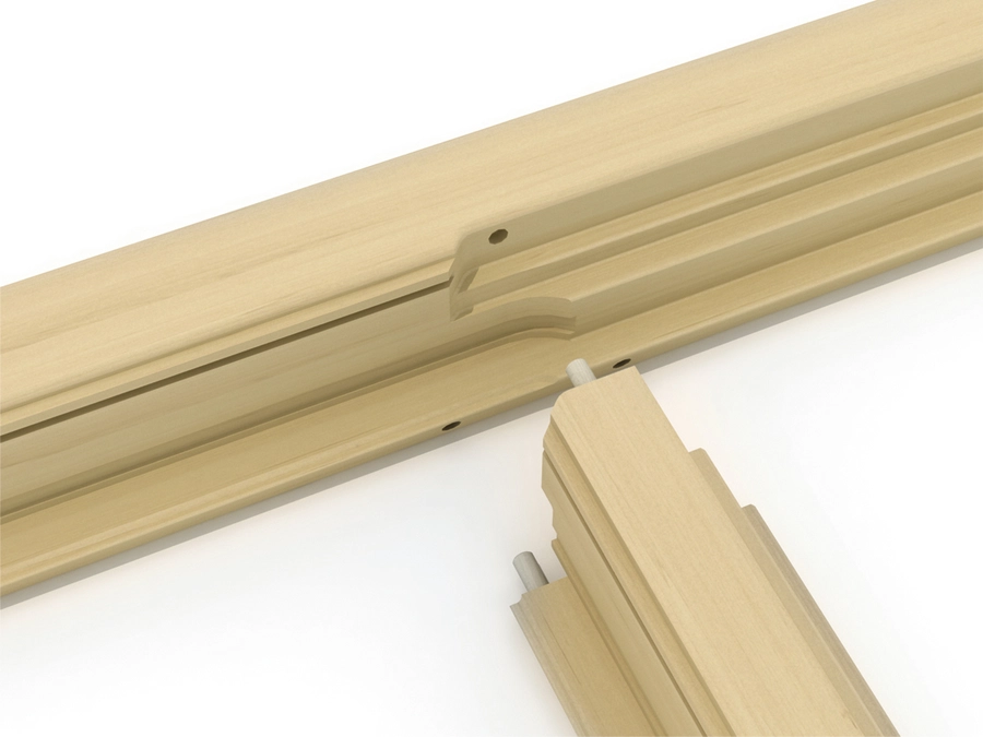 Close-up of pale wood moulding profiles with dowel pin joinery detail on a white background
