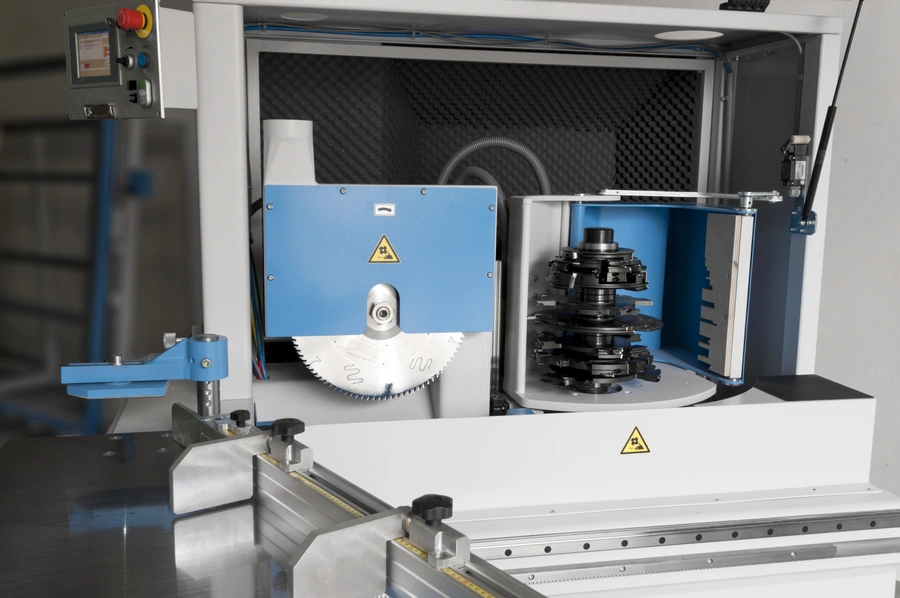 Soukup Temac automatic single end tenoning machine with circular saw blade and stacked cutter heads mounted on blue housing
