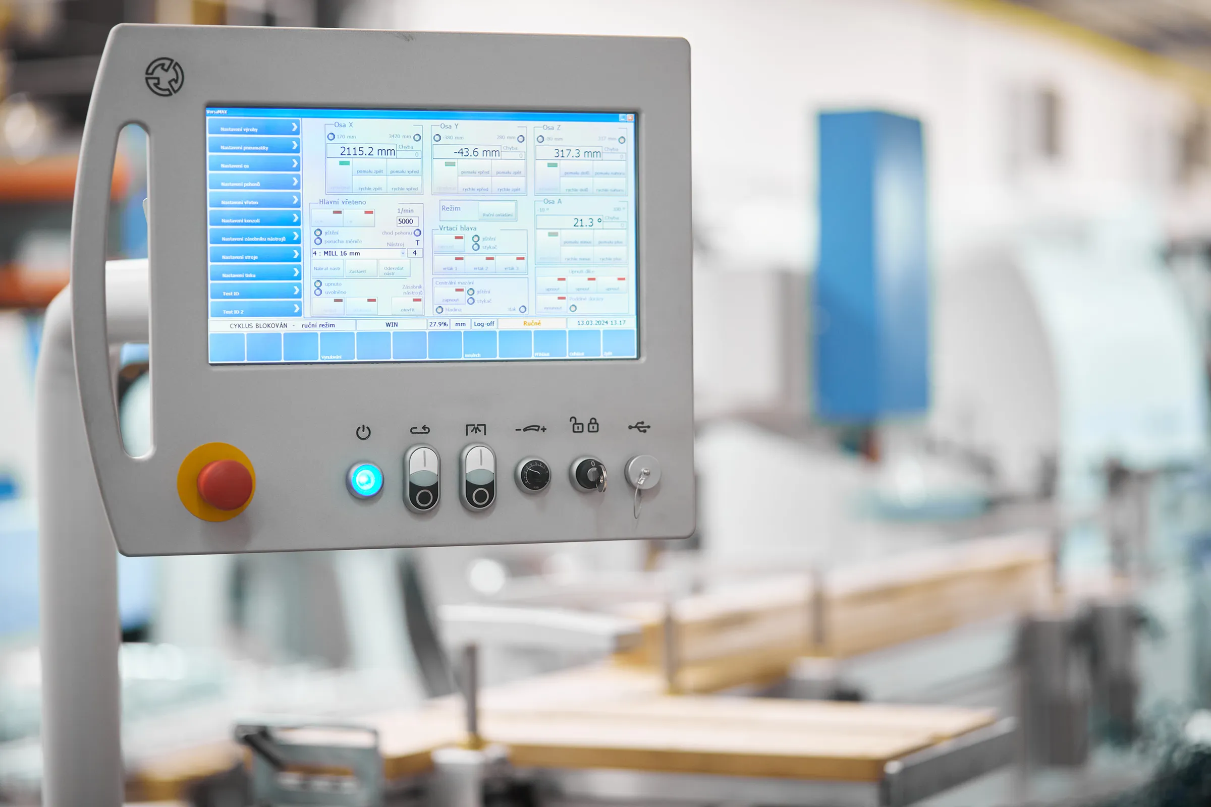 Touchscreen control panel of the Soukup Versa Max showing live X, Y, Z and A axis positions, spindle speed and drilling head status, with emergency stop and key switch below
