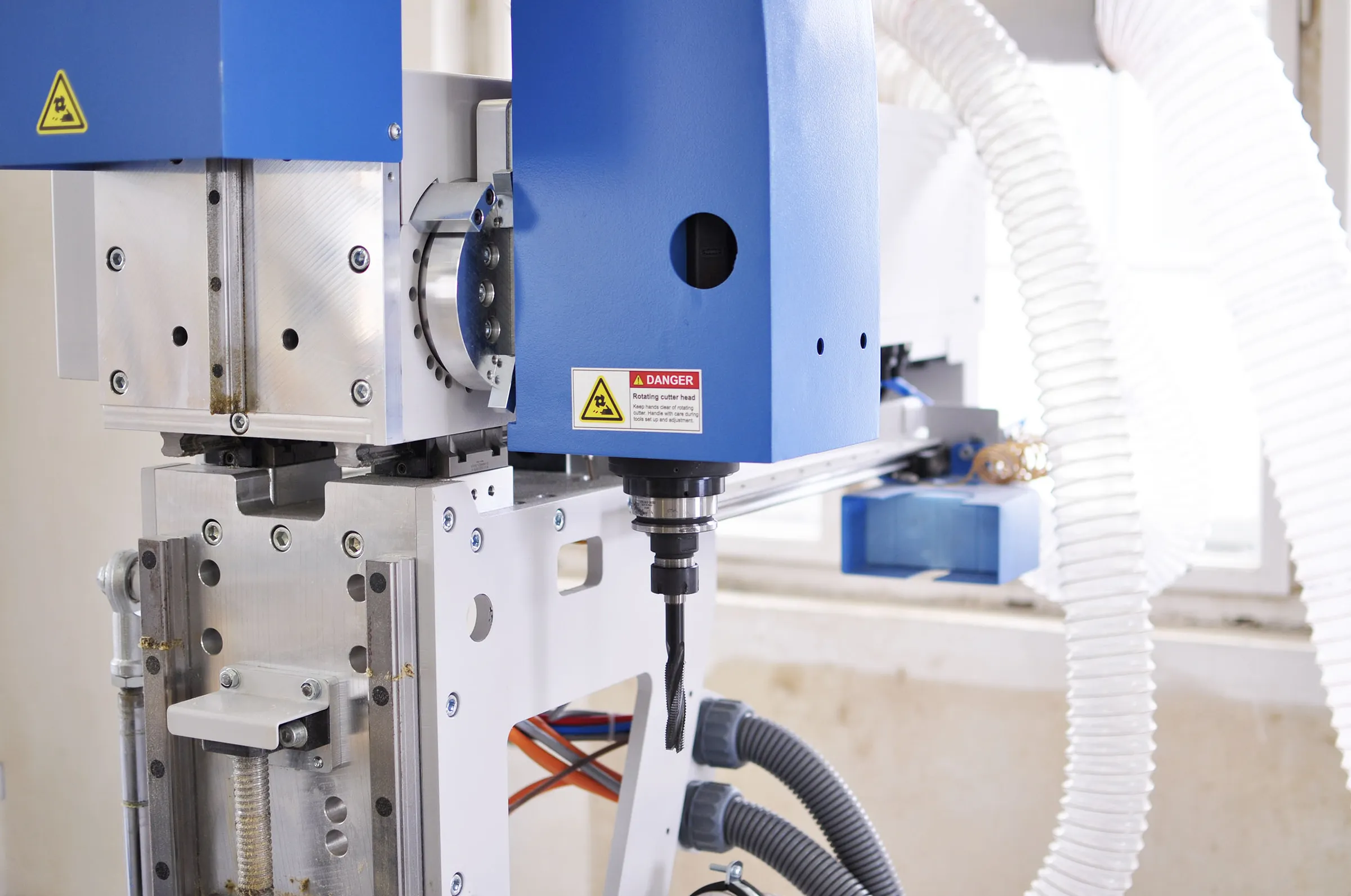Close-up of the Soukup Versa Max main spindle carrying a mortising cutter, with the tilting head casting, linear guides and extraction ducting behind