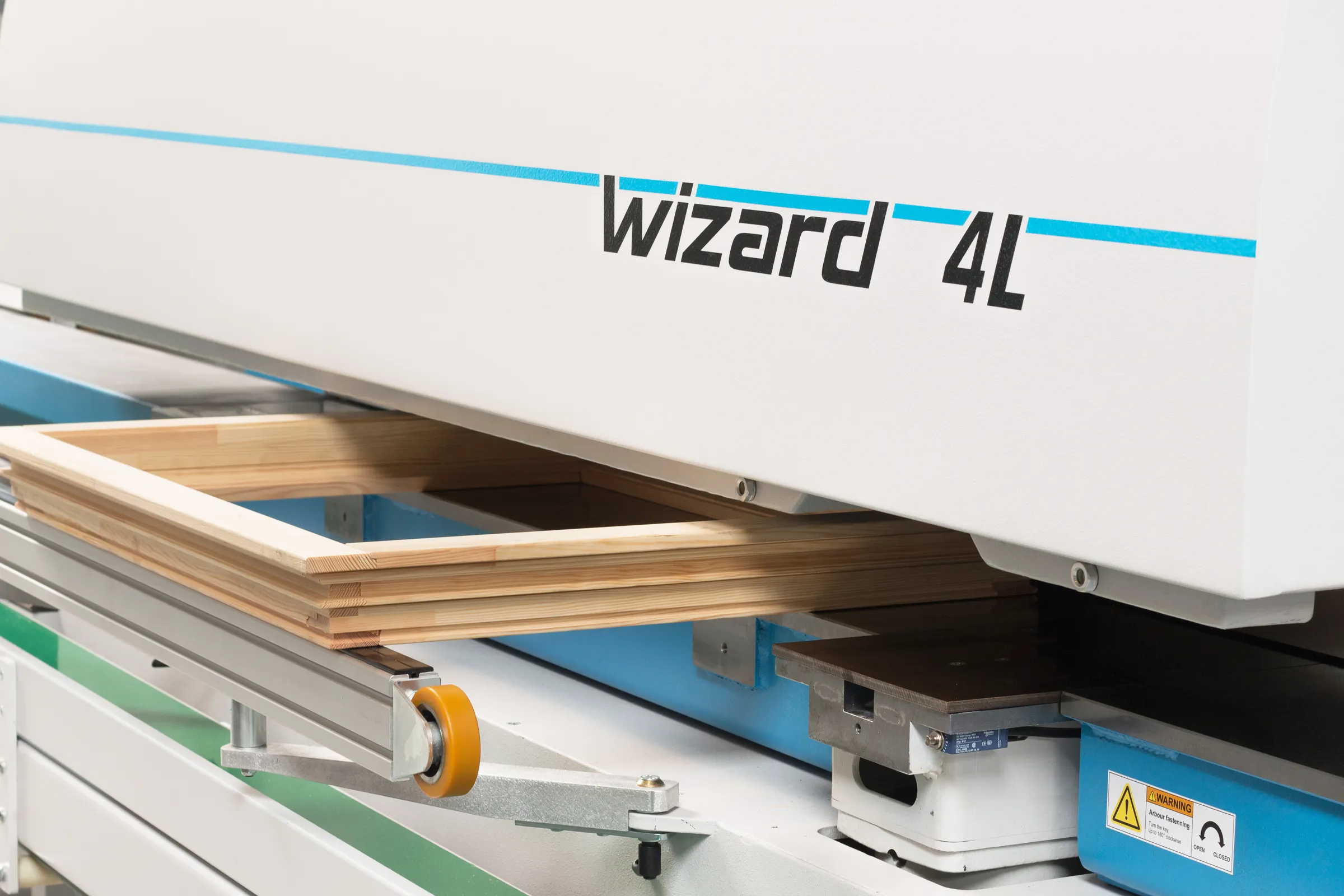 Soukup Wizard 4L CNC window machine processing a wooden window frame on its conveyor bed