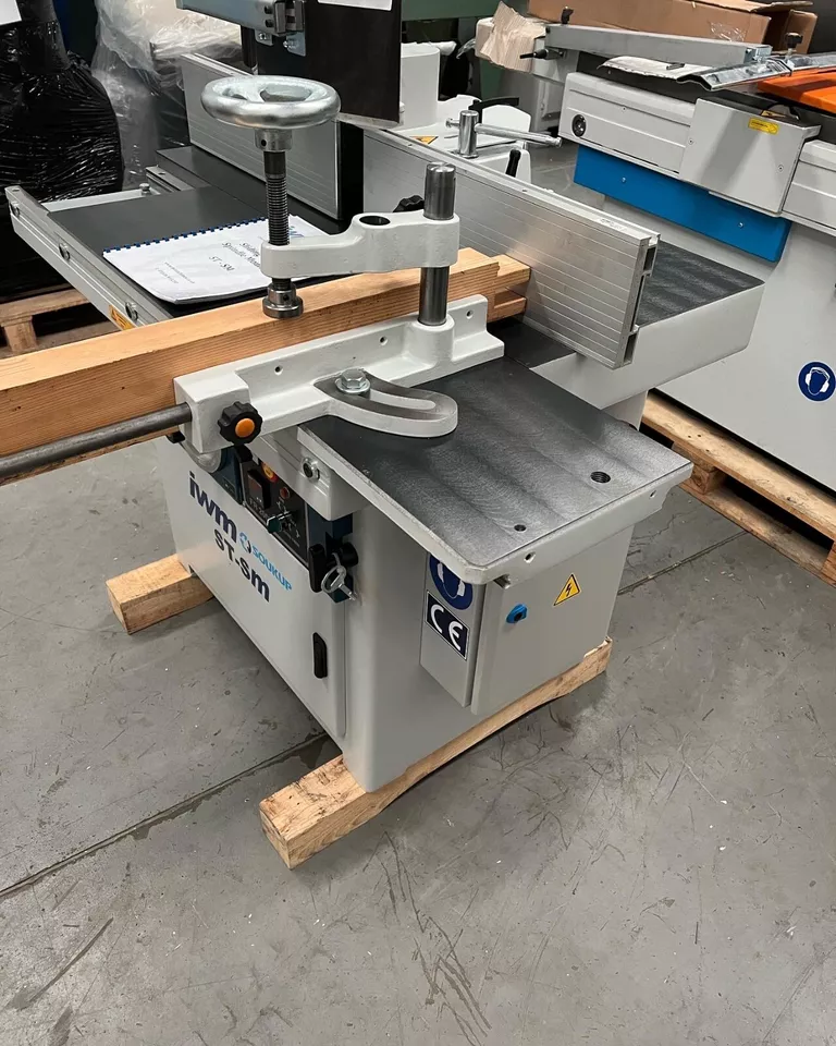 IWM Soukup ST-SM spindle moulder with sliding table, positioned on a wooden pallet in a workshop