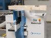 Soukup Notcher machine with a notched timber beam resting on top, in an industrial workshop setting.