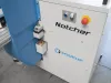 Close-up of a white and blue Soukup Notcher machine with a red emergency stop button and control panel.