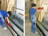 Worker in blue overalls and red gloves using an impregnation and basic coating bath to treat timber lengths in a workshop