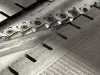 Close-up of a 500mm wide surface planer cutterblock showing carbide insert blades secured with torx screws along the steel drum