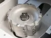 Close-up of a large cylindrical milling cutter head with carbide inserts mounted in a CNC notching machine