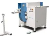 Soukup Notcher machine in white and blue with a roller support stand and foot pedal on a white background