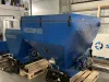 Two blue Falach 50 briquette machines on wooden pallets inside a warehouse