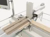 Lateral drilling unit of the Soukup Versa Max boring into the end of a clamped timber section, with a second component held on the cross table alongside