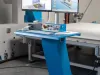 Blue Soukup Pontec CNC machine operator control console with dual Dell monitors displaying 3D CAD software in a factory