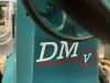 Close-up of a teal Wadkin DM/V vibrating chisel mortiser body, showing the branded DMV logo with red detailing.