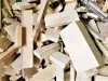 A large pile of pale, rough-cut timber offcuts and wood scraps scattered loosely together