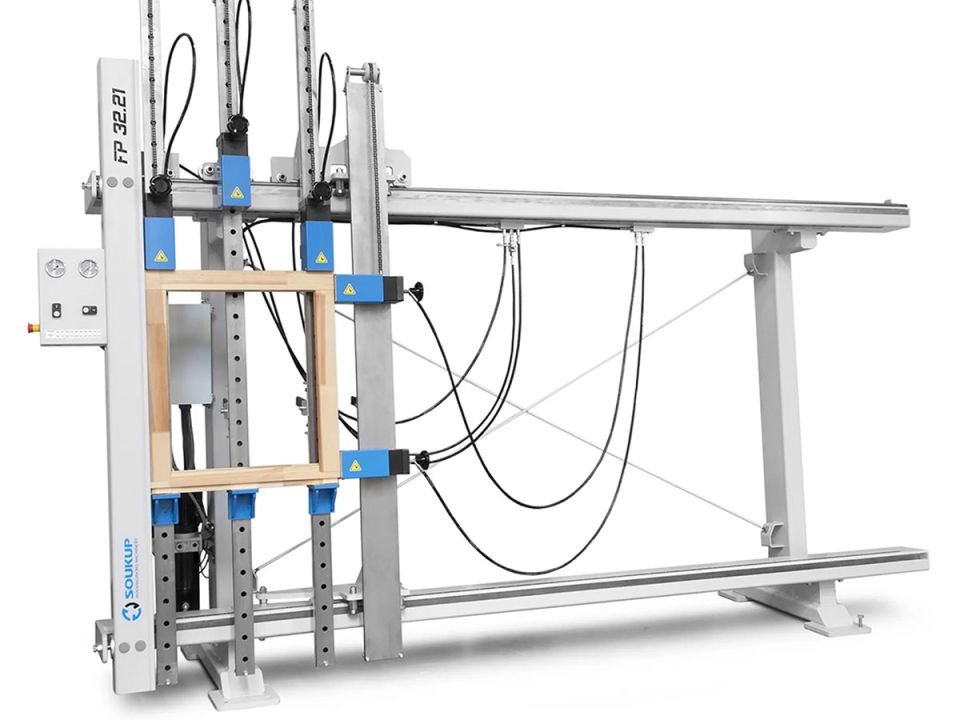 Soukup FP 32.21 window and door frame cramp machine holding a wooden frame with blue pneumatic clamps