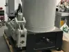IWM Soukup briquette machine mounted on a wooden pallet inside an industrial workshop