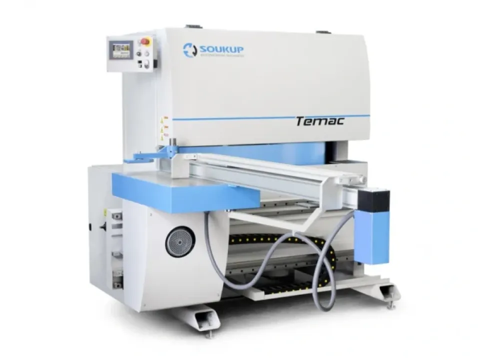 Soukup Temac industrial CNC machine with blue and white casing, control panel, and conveyor feed system on castors