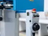Euchner control panel with red emergency stop button and black handwheel dial mounted on industrial machinery