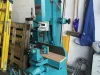 Fully refurbished teal Wadkin DM/V vibrating chisel mortiser on a workshop floor beside a yellow ladder and cleaning tools