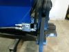 Close-up of numbered hydraulic fittings and hoses on a blue Falach 70 briquette machine frame, labels 13, 17, and 18 visible