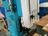 Close-up of a teal Wadkin DM/V vibrating chisel mortiser with a white slotted guard and timber workpiece clamped beneath