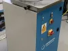 Copenstick end scribe machine with blue and white cabinet, red emergency stop button, and yellow isolator switch on the front panel.