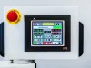 Lange Maschinenbau touchscreen control panel displaying temperature readings, with a red emergency stop button on the left