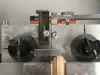 Close-up of a HEP glazing bead end profile scribing machine cutting a wooden bead with twin cutter heads