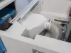 Interior of a Soukup Notcher machine showing a flexible ventilation duct, wiring, and white internal panels