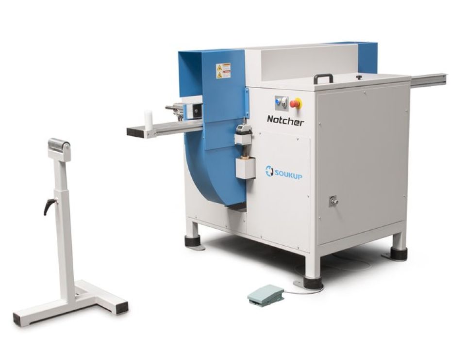 Soukup Notcher industrial notching machine in grey and blue with a roller support stand and foot pedal
