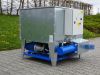 BrikStar EK 20 industrial briquetting machine with blue hydraulic unit and grey steel casing, mounted on a blue steel frame outdoors