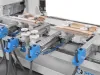 Soukup Spectra CNC working centre with blue clamps, white rollers, and timber strips secured on aluminium rail tracks