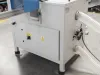 White industrial Soukup Notcher unit with flexible extraction hoses and warning labels, situated on a factory floor.