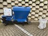 Falach 50 briquette machine in blue with control panel, hopper, and discharge hose on a paved surface
