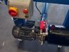 Eaton motor starter control box with red isolator switch mounted above a hydraulic pump motor assembly on a blue steel frame