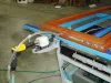 Soukup Assembling Table KS 2400 with orange and blue frame sections, pneumatic tool attachment, and hose on workshop floor