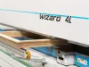 Soukup Wizard 4L CNC window machine processing a wooden window frame on its conveyor bed