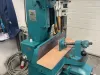 Fully refurbished teal Wadkin Bursgreen mortising machine with timber workpiece clamped on the table in a workshop