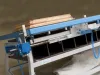 Soukup Assembling Table KS 2400 with blue frame, timber strips stacked on top, pneumatic fittings and segmented storage below