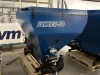 Falach 50XL blue briquette machine on a wooden pallet inside an industrial warehouse