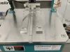 IWM Soukup HEP glazing bead end profile scribing machine with aluminium worktop, teal cabinet, and warning labels on castors