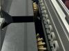 Close-up of industrial brushes and rollers along a conveyor track on a 3U SISAN machine